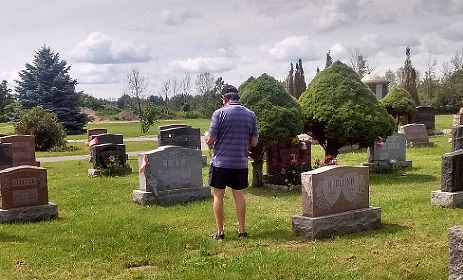 Tour pauses at cemetery marker