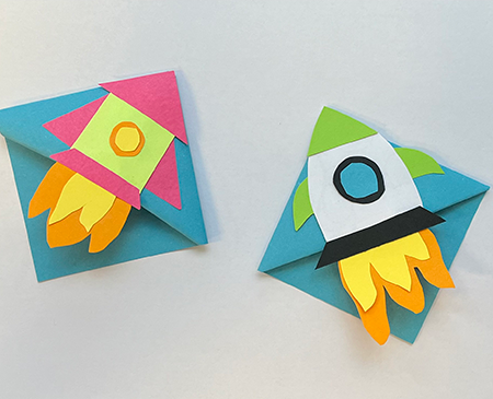 Two origami bookmarks shaped as rockets