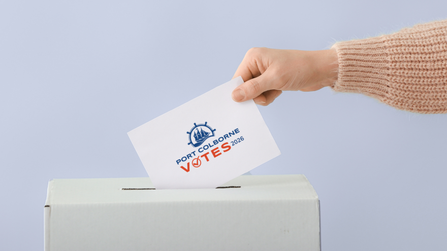 hand submitting ballot in box